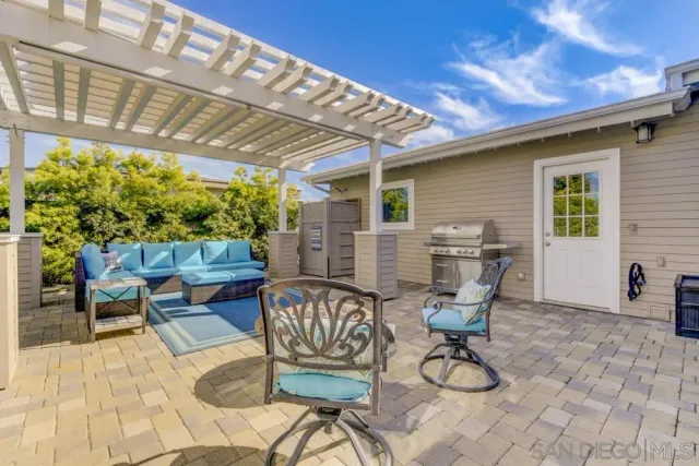 a view of a patio with a table and chairs
