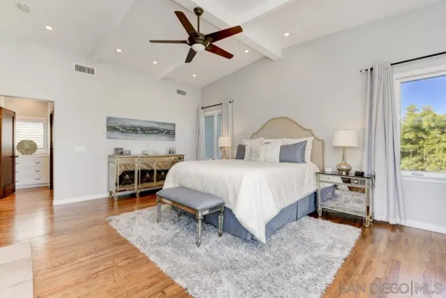 a bed room with a bed and a chandelier