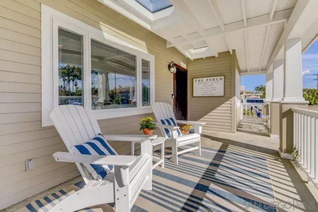 a view of a patio with table and chairs and wooden floor