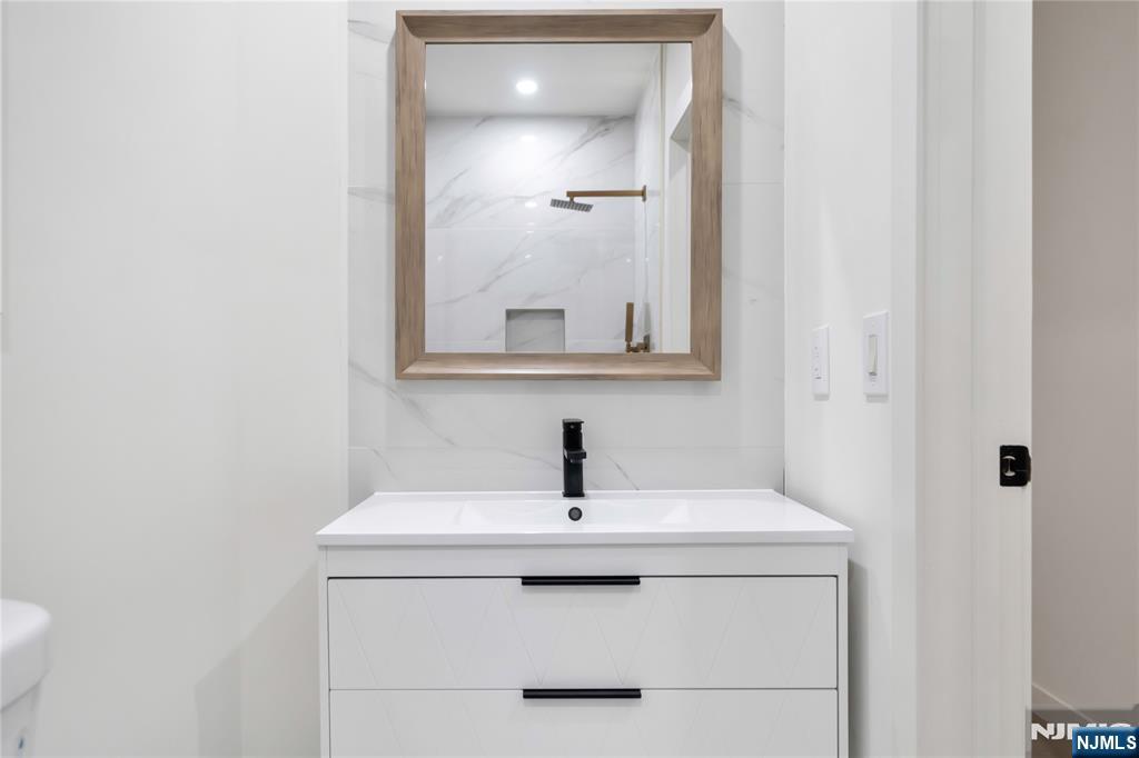 468 Morse Avenue Ridgefield, NJ 07657 - Photo 45 of 48 a bathroom with a sink and mirror