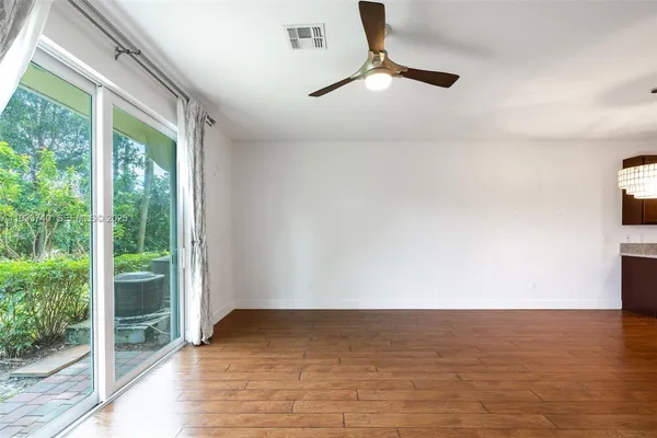 a view of kitchen with sink and wooden floor