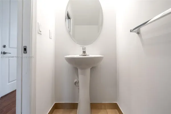 a bathroom with a sink a mirror and shower