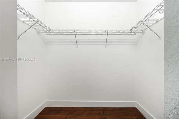an empty room with wooden floor and a window