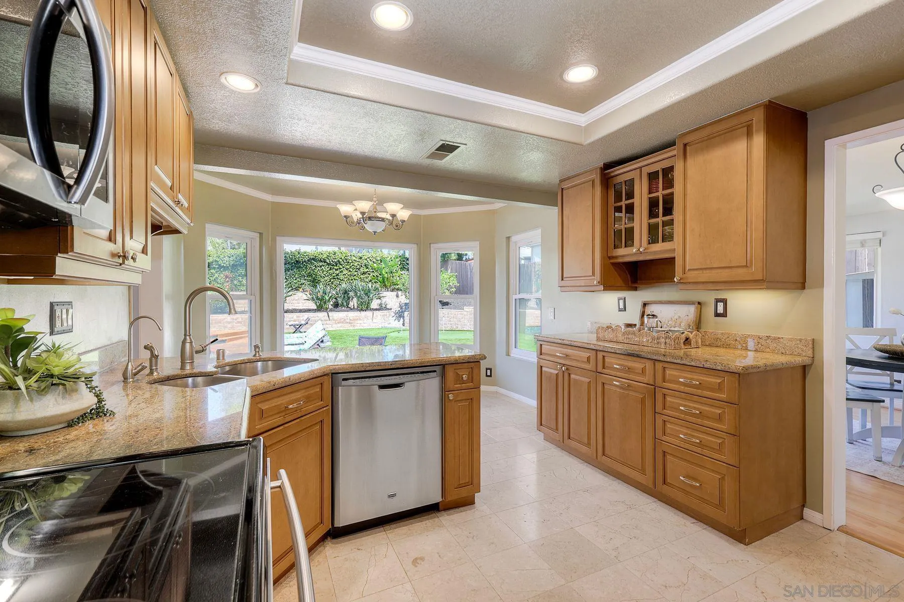 13976 Country Creek Road Poway, CA 92064 - Photo 8 of 40 a large kitchen with stainless steel appliances granite countertop a sink counter space cabinets and a large window