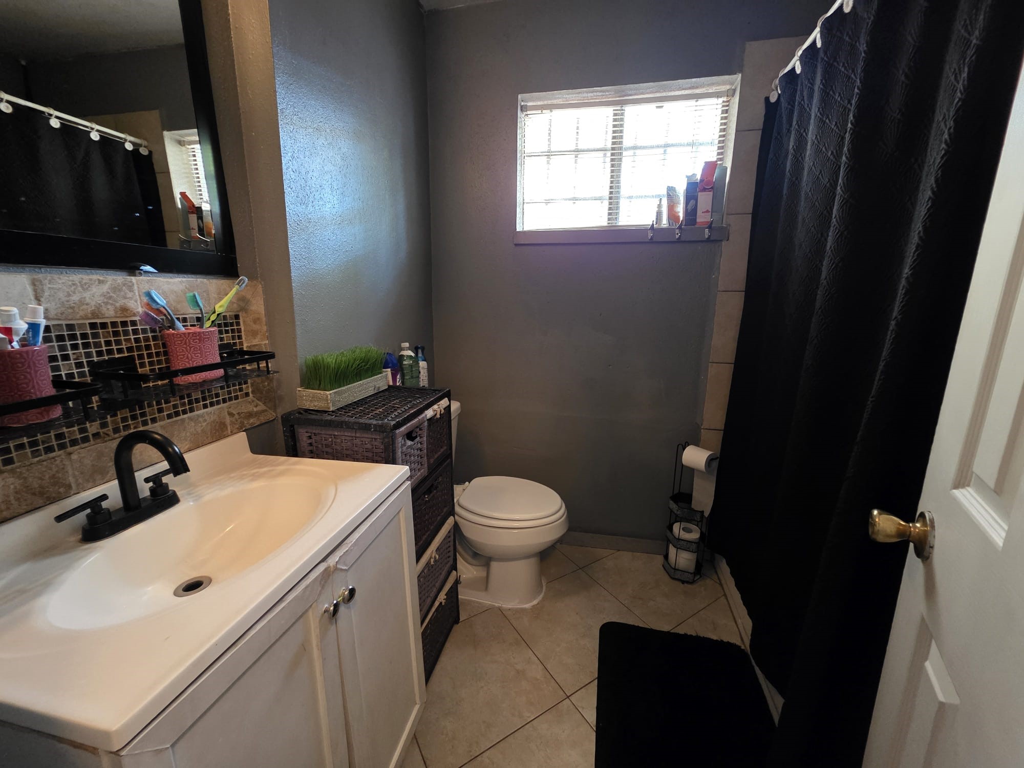 2415 West Little York Road, Unit D Houston, TX 77091 - Photo 8 of 16 a bathroom with a sink toilet and shower