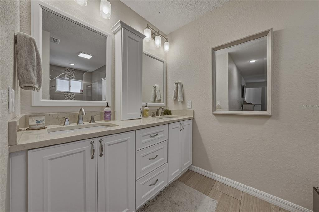7435 Kilbride Court Weeki Wachee, FL 34613 - Photo 38 of 67 a bathroom with a double vanity sink and a mirror