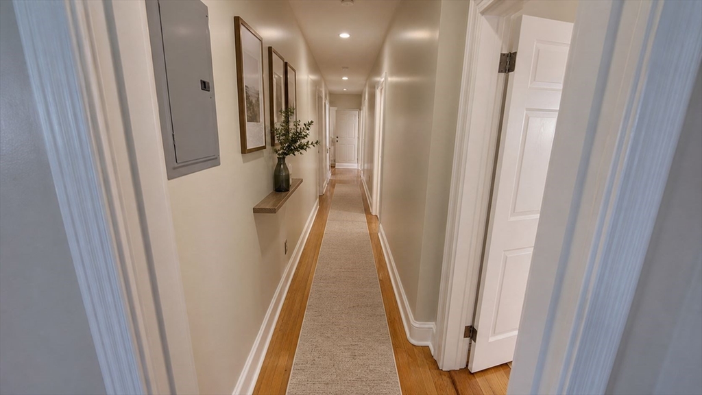 35 Catawba Street, Unit 2 Boston, MA 02119 - Photo 6 of 15 a view of a hallway with wooden floor and stairs