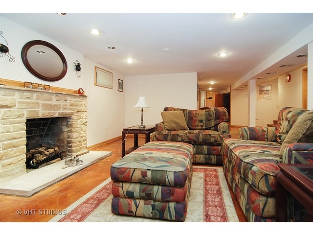 732 Selborne Road Riverside, IL 60546 - Photo 13 of 23 a living room with furniture a fireplace and a flat screen tv