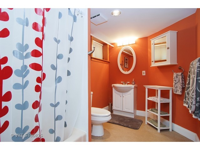 732 Selborne Road Riverside, IL 60546 - Photo 17 of 23 a bathroom with a toilet and a shower curtain
