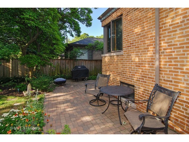 732 Selborne Road Riverside, IL 60546 - Photo 19 of 23 a backyard of a house with table and chairs