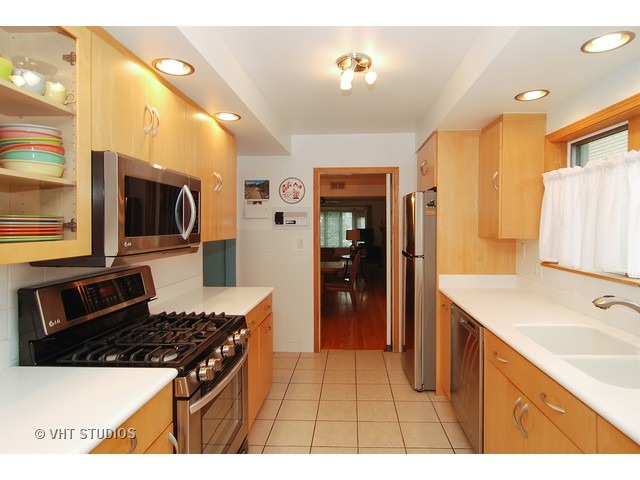 732 Selborne Road Riverside, IL 60546 - Photo 7 of 23 a kitchen with stainless steel appliances granite countertop a sink stove and refrigerator