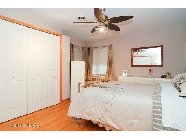 732 Selborne Road Riverside, IL 60546 - Photo 9 of 23 a view of a bedroom with a bed and a chandelier fan