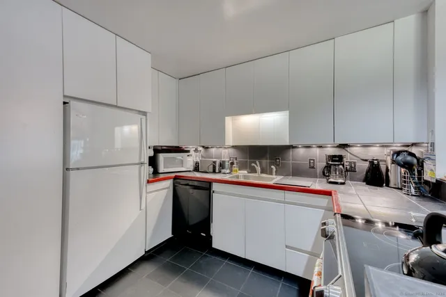a kitchen with a refrigerator and a sink