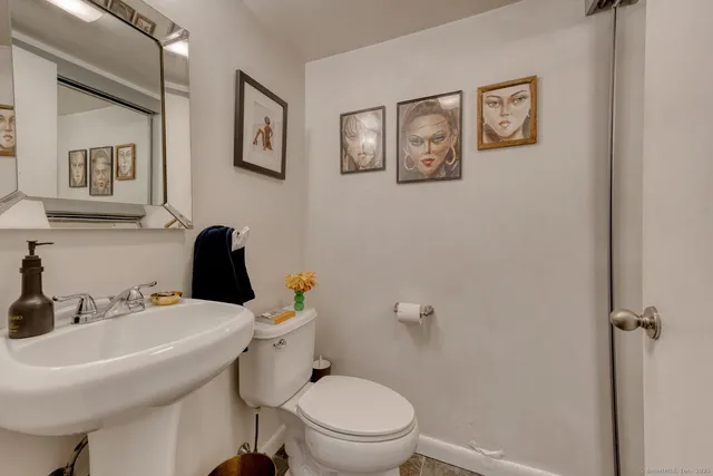 a bathroom with a sink mirror and toilet
