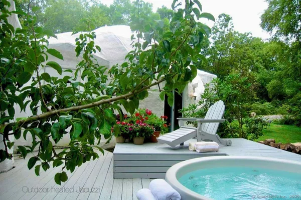 a view of a house with a yard and fountain