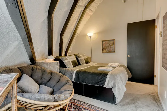 a bedroom with bed and a couch