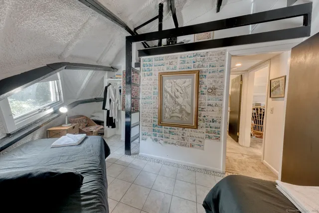 a bathroom with a tub shower and mirror