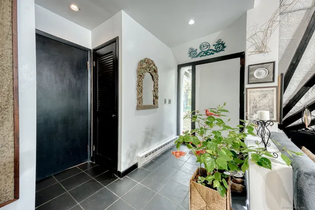 a hallway with painting and flowers