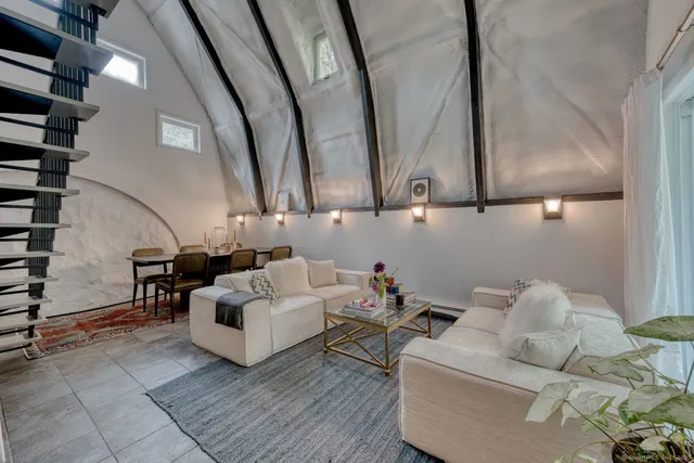 a kitchen with a refrigerator and white cabinets