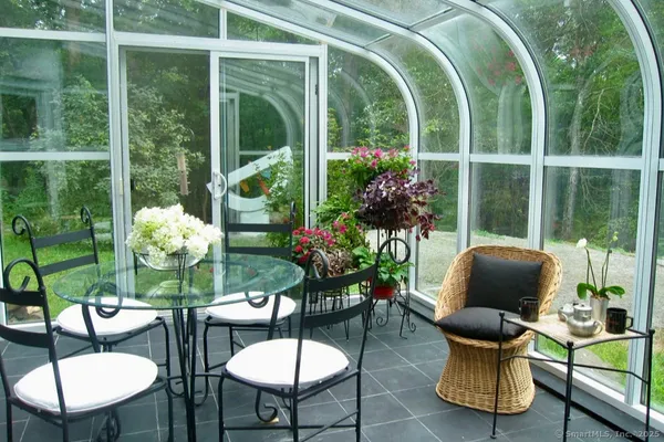 a living room with furniture and a painting on the wall