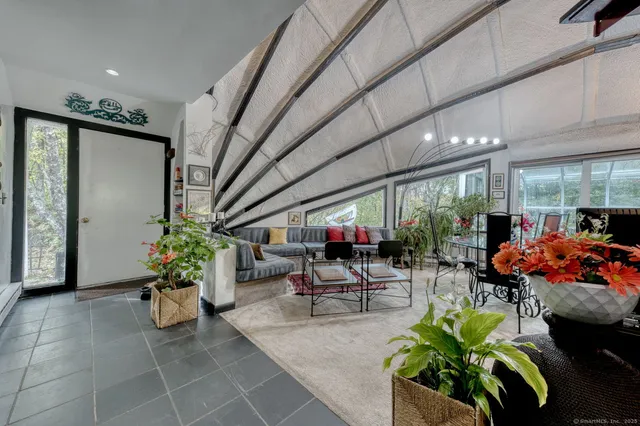 a lobby with furniture and potted plants
