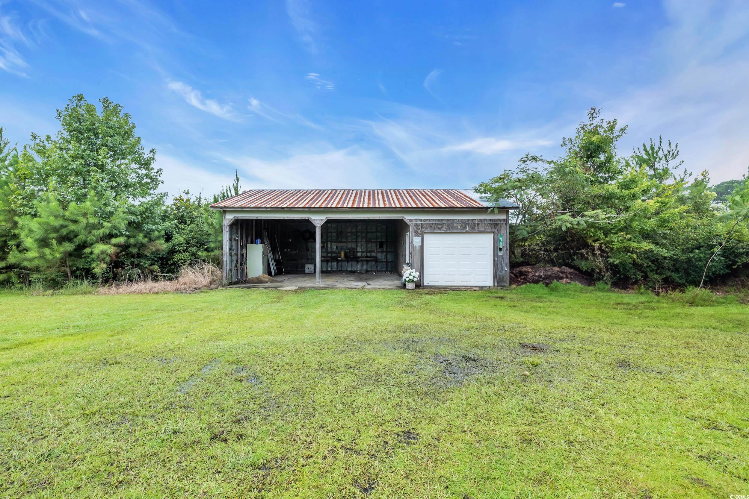 1928 Emery Road Loris, SC 29569 - Photo 21 of 24 View of pole building with a lawn