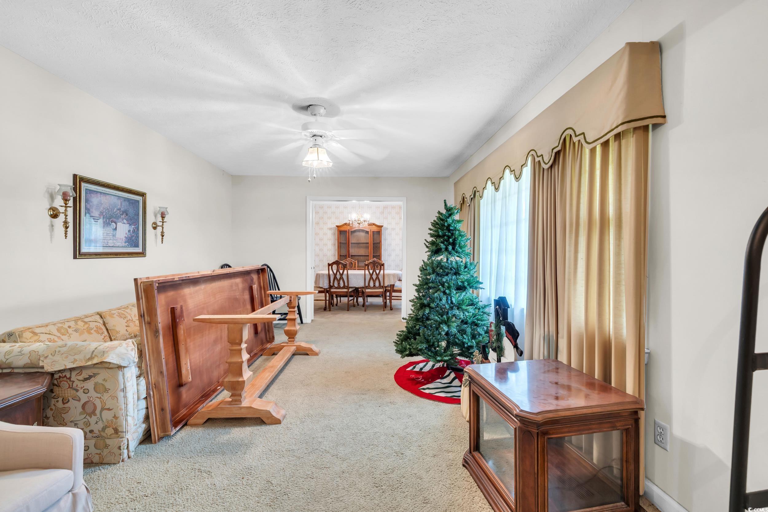 1928 Emery Road Loris, SC 29569 - Photo 8 of 24 Sitting room with carpet, a textured ceiling, and ceiling fan