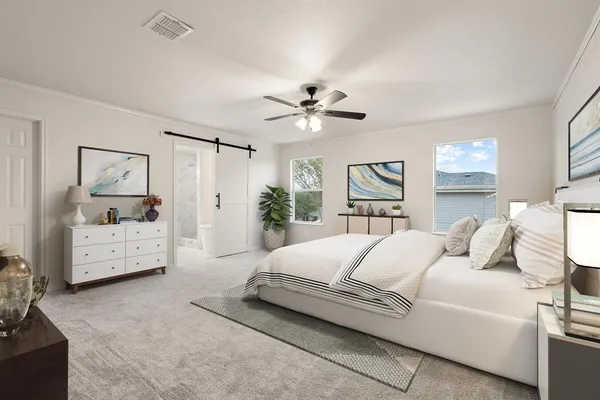 a bedroom with a large bed and a chandelier