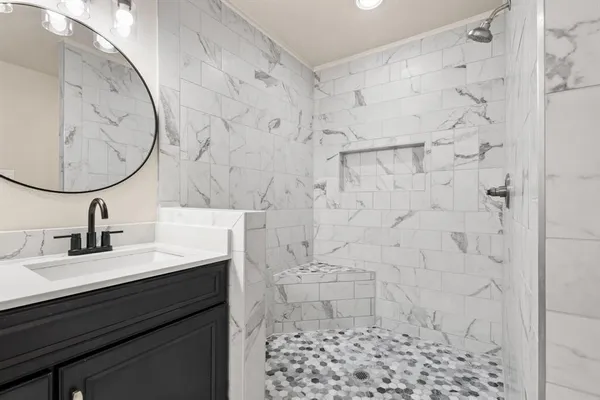 a bathroom with a sink a toilet and a mirror