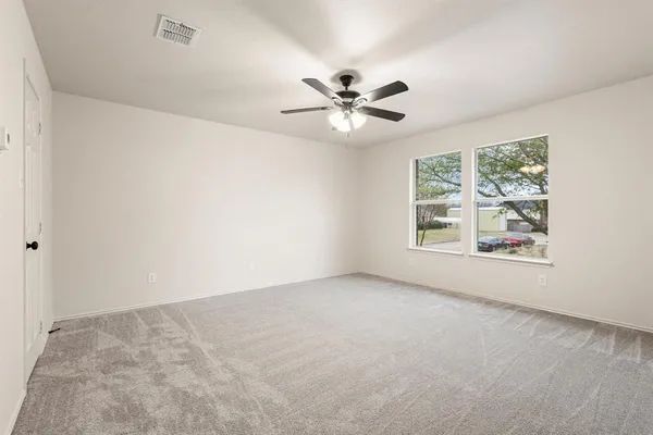 a view of room with a ceiling fan and a window