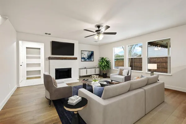 a living room with furniture a fireplace and a flat screen tv