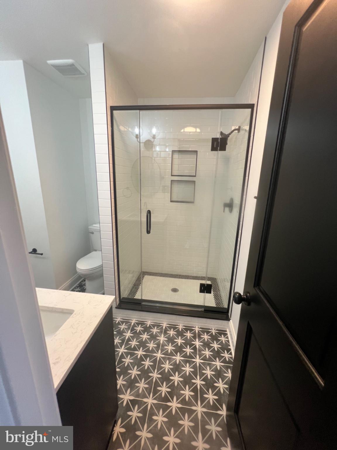 4400 Rendale Court Olney, MD 20832 - Photo 12 of 47 Sleek modern bathroom with stylish tiles.