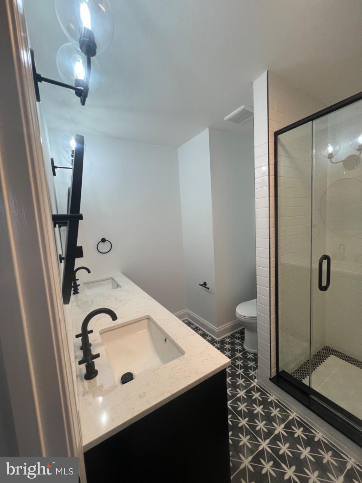 4400 Rendale Court Olney, MD 20832 - Photo 13 of 47 Sleek modern bathroom with stylish tiles.