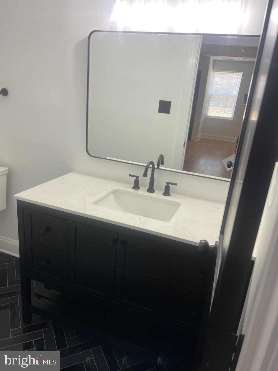 4400 Rendale Court Olney, MD 20832 - Photo 44 of 47 Sleek modern bathroom with elegance.