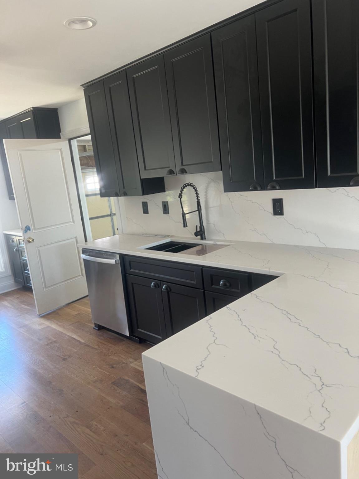 4400 Rendale Court Olney, MD 20832 - Photo 5 of 47 Sleek black cabinetry meets marble elegance.