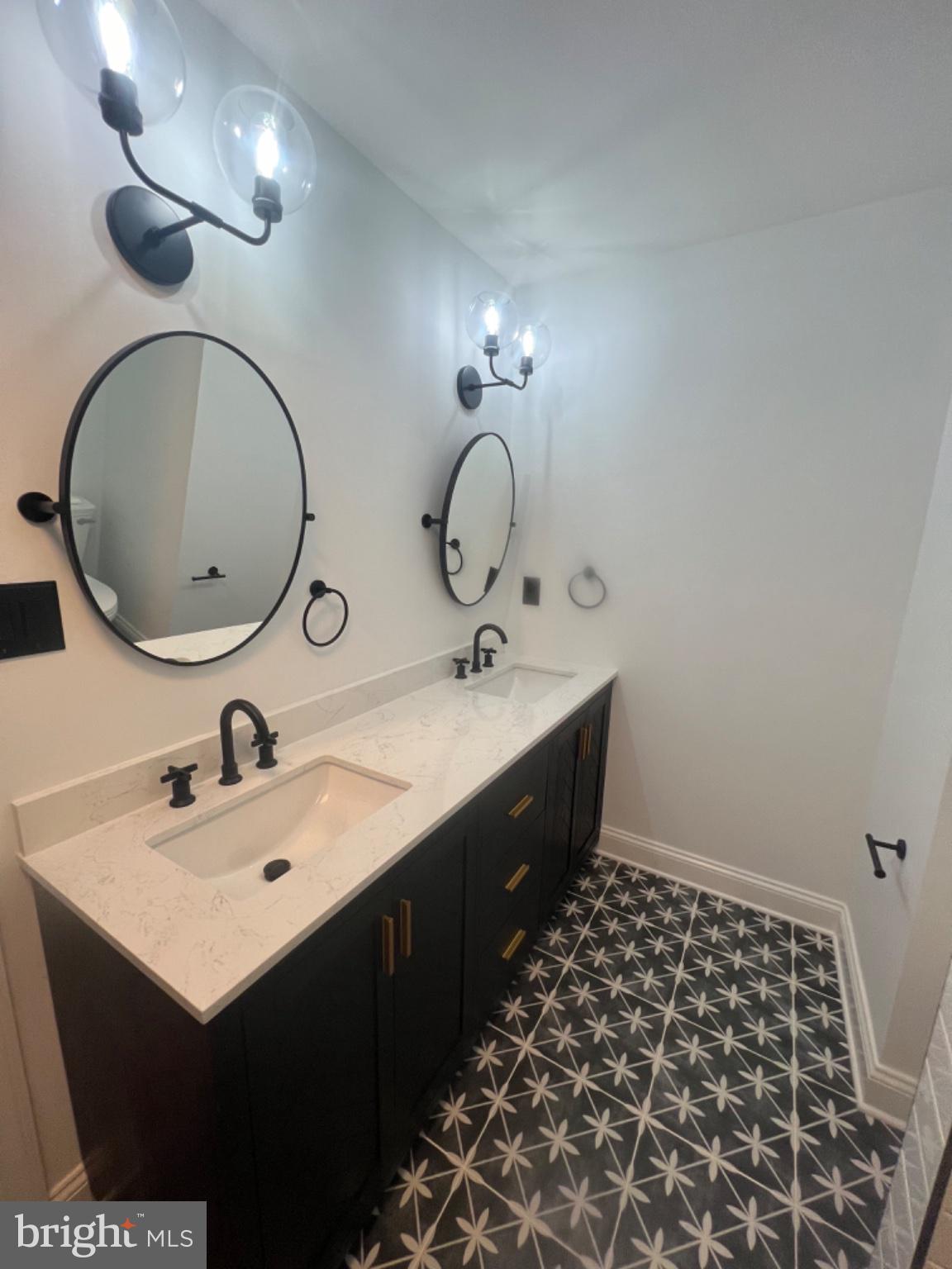 4400 Rendale Court Olney, MD 20832 - Photo 9 of 47 Sleek modern bathroom with stylish tiles.