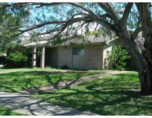a yellow house in middle of the forest