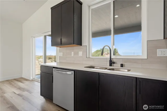 a large kitchen with kitchen island a refrigerator a stove a sink and a oven