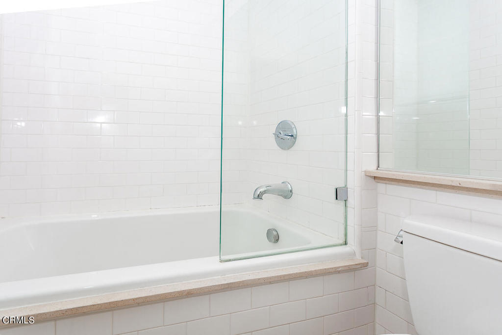 257 South Spring Street, Unit PHE Los Angeles, CA 90012 - Photo 13 of 29 a bathroom with a bathtub and a shower