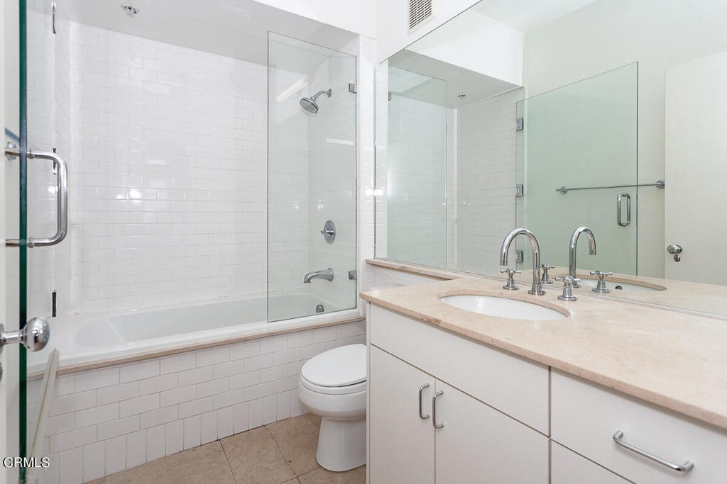 257 South Spring Street, Unit PHE Los Angeles, CA 90012 - Photo 14 of 29 a bathroom with a granite countertop sink toilet and shower
