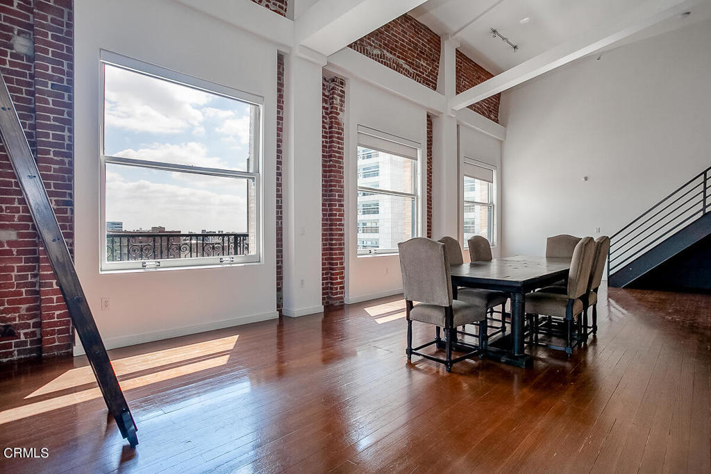 257 South Spring Street, Unit PHE Los Angeles, CA 90012 - Photo 5 of 29 a view of a dining room with furniture window and wooden floor