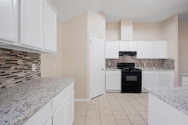 an empty room with windows and entrance