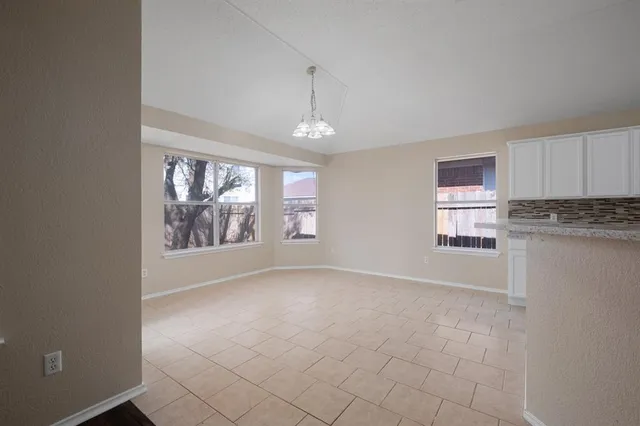 a kitchen with stainless steel appliances a refrigerator and a stove top oven