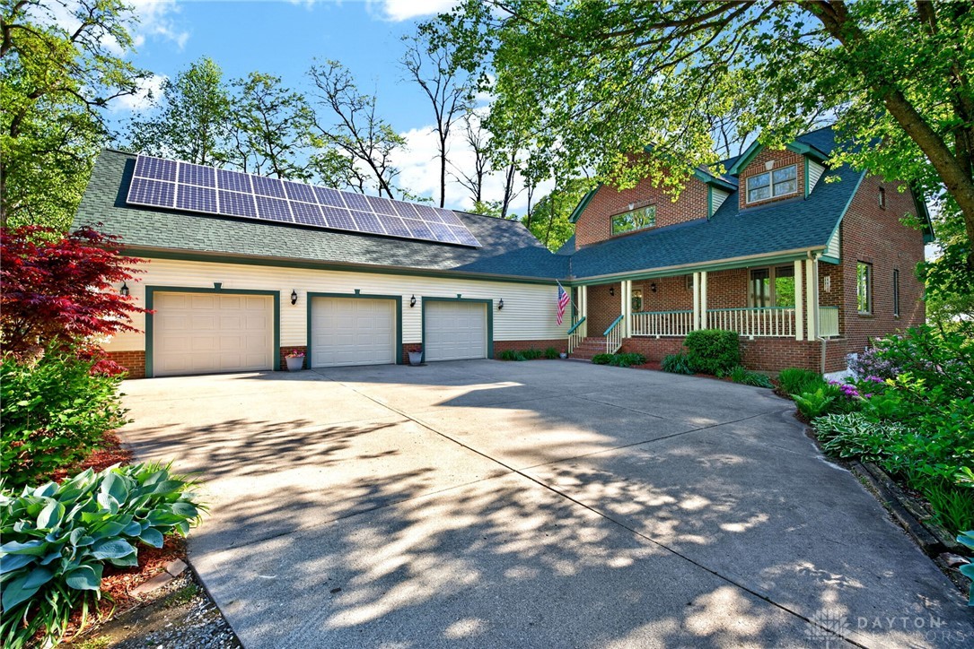330 South Alpha Bellbrook Road Bellbrook, OH 45305 - Photo 3 of 87 This beautiful brick home features a spacious driveway, a three-car garage, and lush green landscaping.