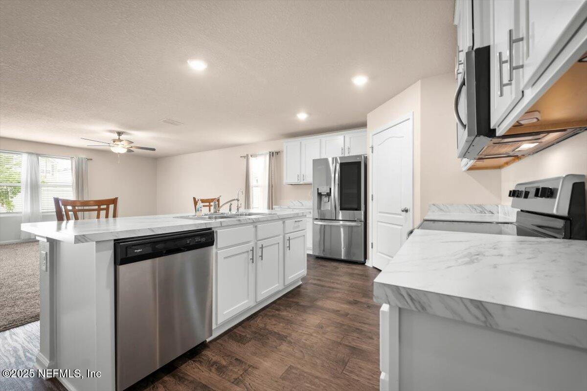 2080 Denton Trace Green Cove Springs, FL 32043 - Photo 12 of 32 a kitchen with stainless steel appliances granite countertop a sink a stove and a refrigerator