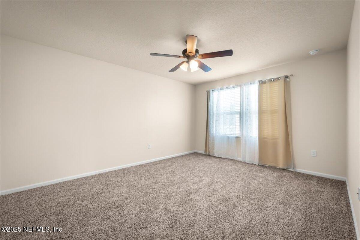 2080 Denton Trace Green Cove Springs, FL 32043 - Photo 23 of 32 an empty room with windows and fan