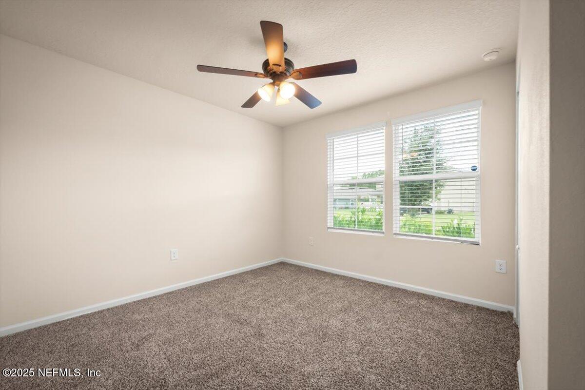 2080 Denton Trace Green Cove Springs, FL 32043 - Photo 3 of 32 an empty room with windows and fan