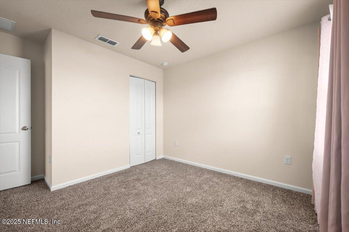 2080 Denton Trace Green Cove Springs, FL 32043 - Photo 7 of 32 an empty room with a fan and a fan