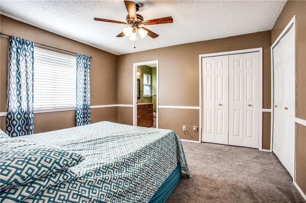 6817 Haltom Road Fort Worth, TX 76137 - Photo 11 of 25 Carpeted room featuring a ceiling fan with light fixture, window with blinds, and white bi-fold closet doors