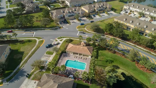 an aerial view of a house with a yard and lake view